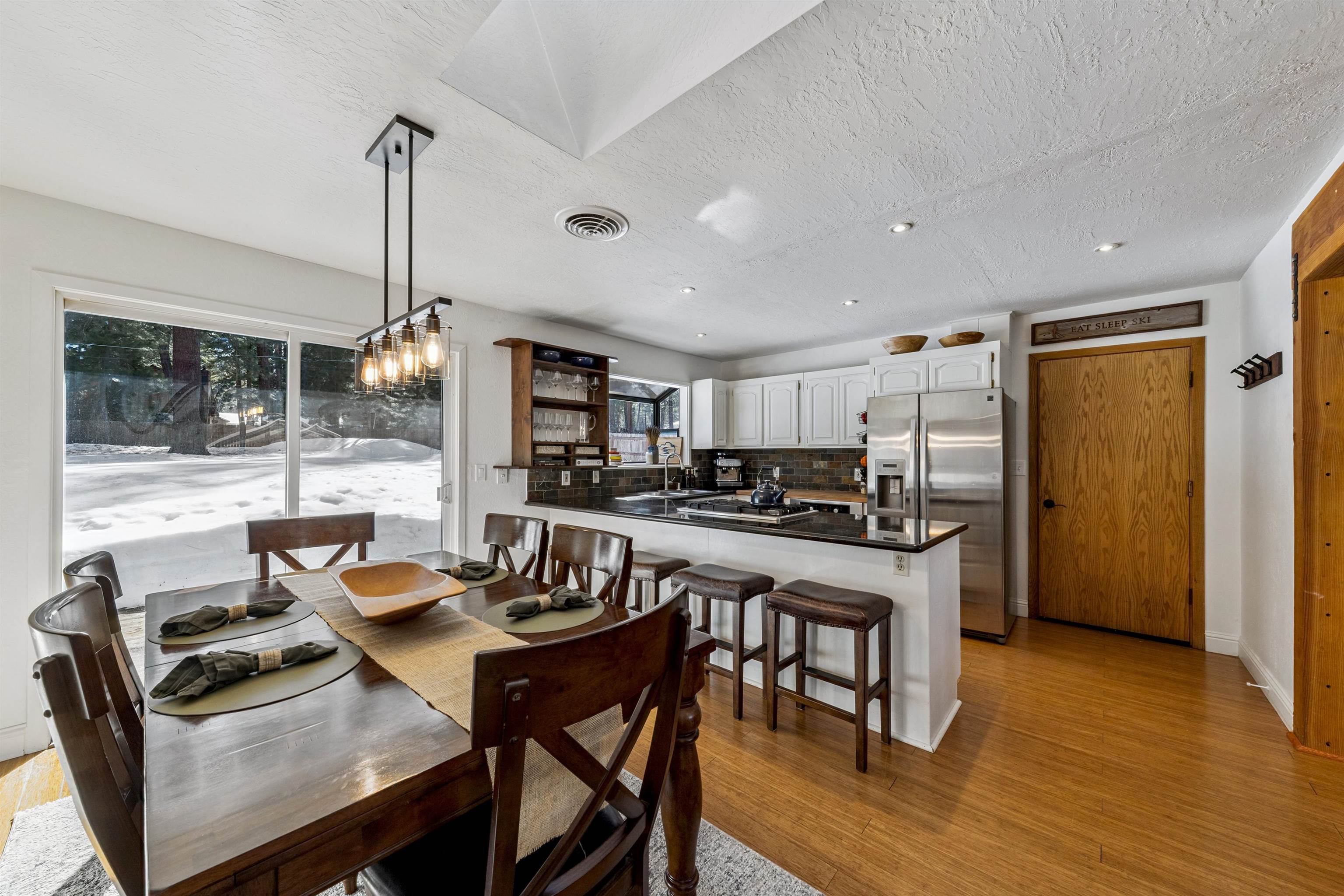 10895 Jeffery Pine Road Truckee, CA 96161 - Photo 11 of 25 a kitchen with stainless steel appliances granite countertop a stove a refrigerator a kitchen island a table and chairs