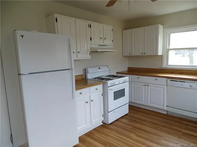 a white refrigerator freezer sitting inside of a kitchen