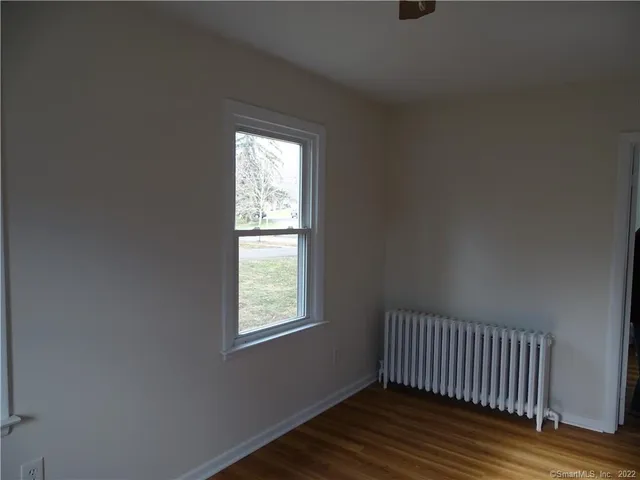 a view of a room with wooden floor and windows