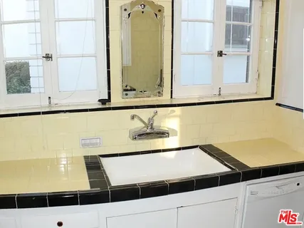a view of a room with wooden floor and a bookshelf