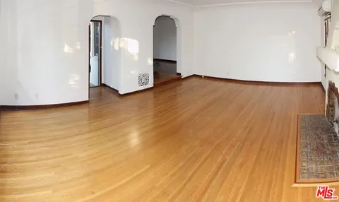a view of a room with wooden floor and cabinet