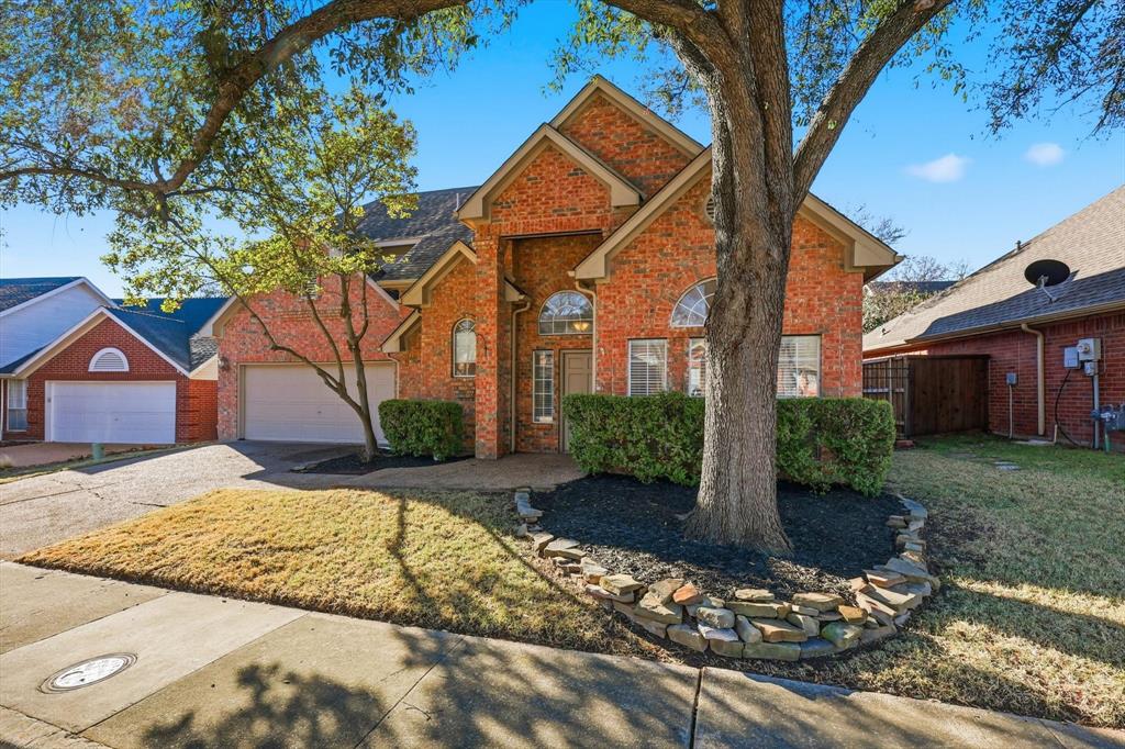 5023 Falcon Hollow Road McKinney, TX 75072 - Photo 3 of 25 Traditional home featuring concrete driveway, brick siding, and a garage