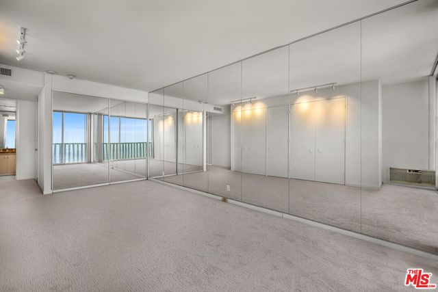 a view of an empty room and a window