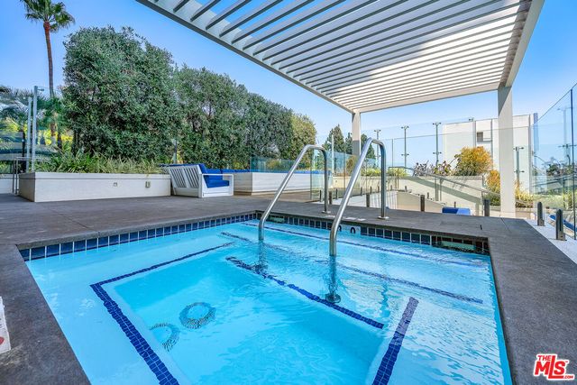 a view of a patio with a table and chairs under an umbrella