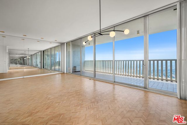 a dining hall with stainless steel appliances kitchen island granite countertop a dining table chairs and view living room