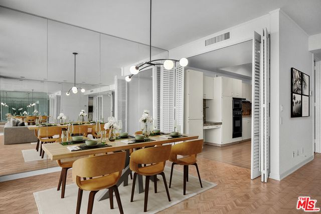 a view of a big room with wooden floor and a kitchen
