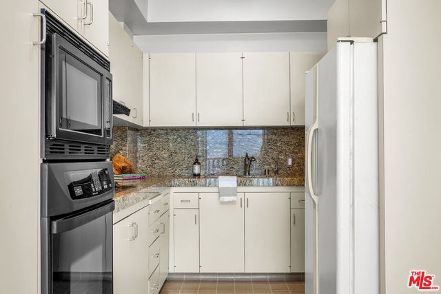 a large bedroom with a bed and a chandelier