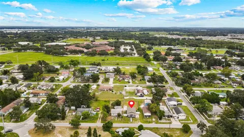 an aerial view of residential houses with outdoor space