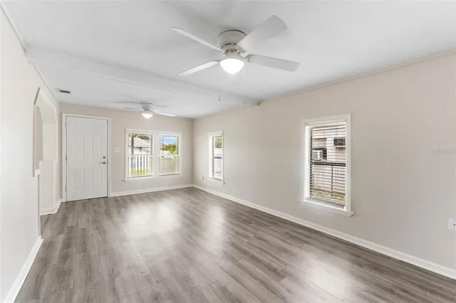 wooden floor in an empty room with a window