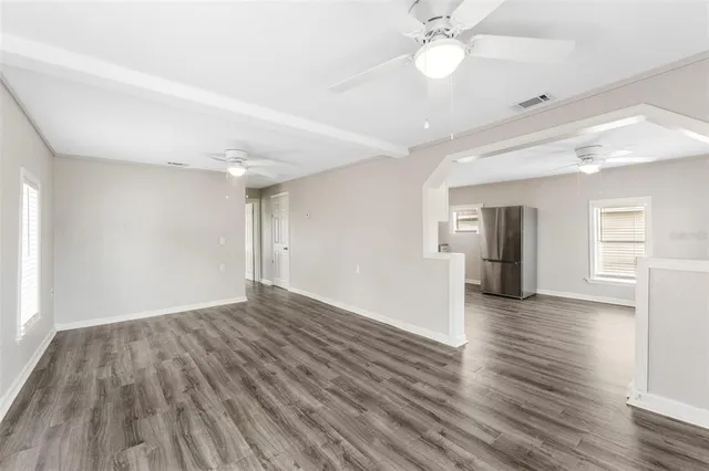 wooden floor in an empty room with a window