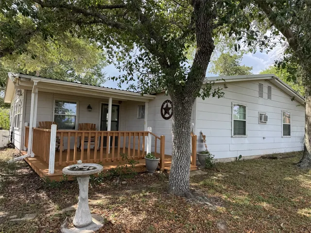 a view of a house with backyard and porch