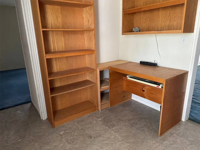 a view of an empty room with empty shelves