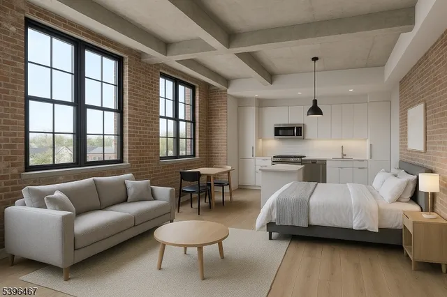 a spacious bedroom with a bed and a couch