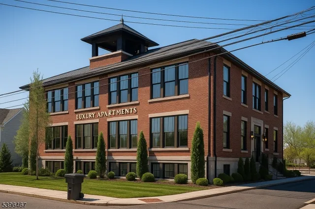 a front view of a residential apartment building with a yard