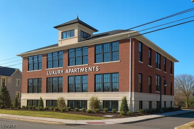 a front view of a building with a yard