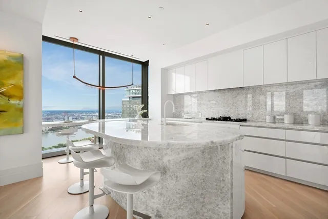 a kitchen with stainless steel appliances granite countertop a sink and cabinets