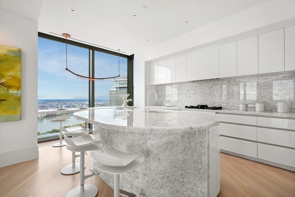 1 Dalton Street, Unit 5801/5802 Boston, MA 02115 - Photo 15 of 28 a kitchen with stainless steel appliances granite countertop a sink and cabinets