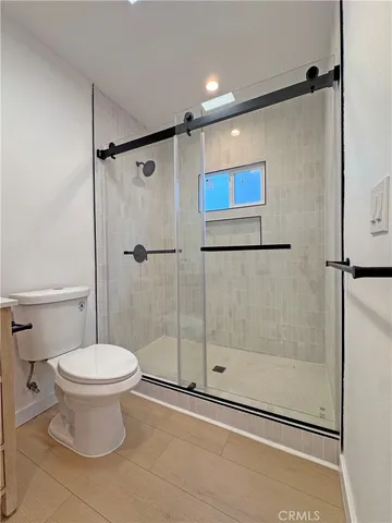 a bathroom with a toilet and a shower