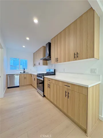 a kitchen with wooden cabinets and white appliances