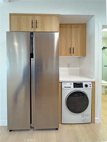 a view of a kitchen with a sink washer and dryer