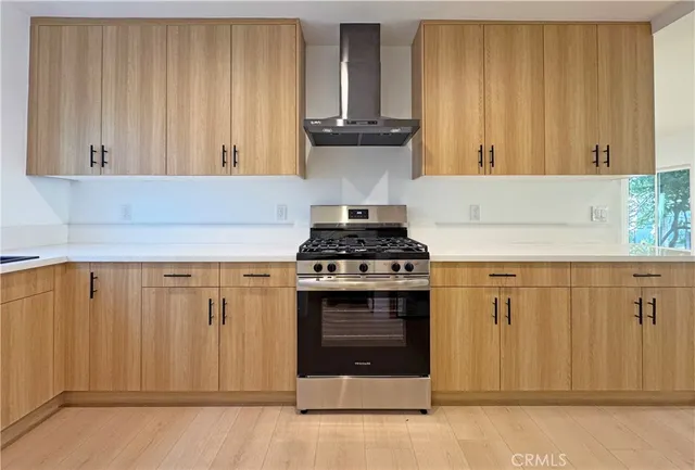 a kitchen with granite countertop a stove sink and cabinets