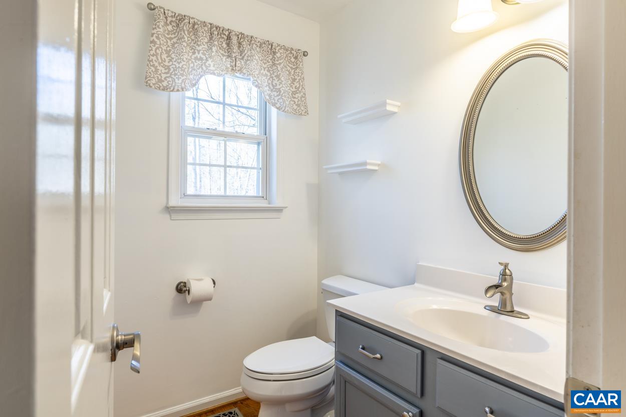 35 Zephyr Road Palmyra, VA 22963 - Photo 17 of 51 a bathroom with a granite countertop toilet a sink and a mirror