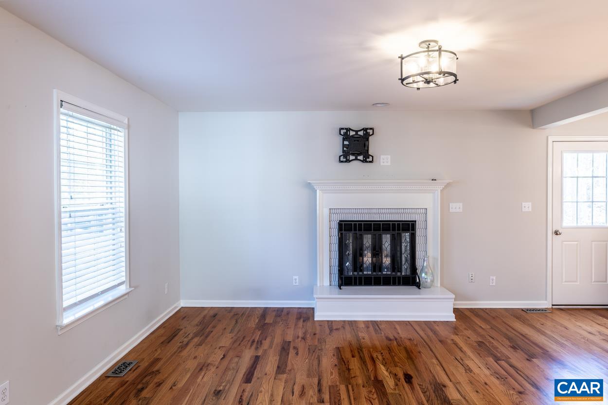 35 Zephyr Road Palmyra, VA 22963 - Photo 5 of 51 a view of an empty room with wooden floor fireplace and a window