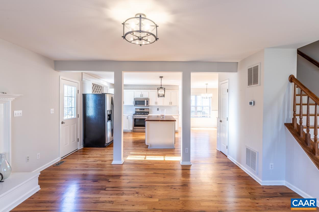 35 Zephyr Road Palmyra, VA 22963 - Photo 6 of 51 a view of a hallway with wooden floor and chandelier
