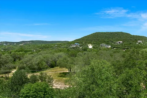 a view of a lush green outdoor space with a lake view