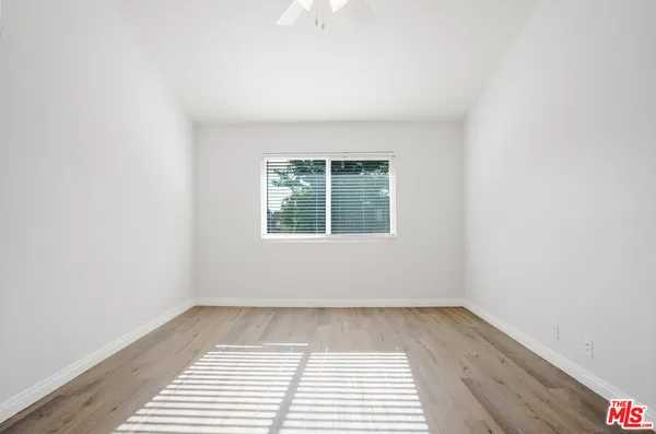 a view of a room with wooden floor and white walls