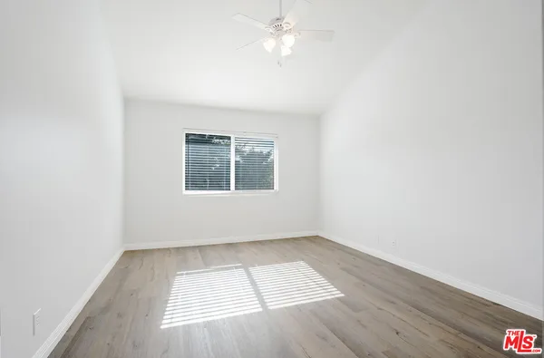 a view of a room with wooden floor and staircase