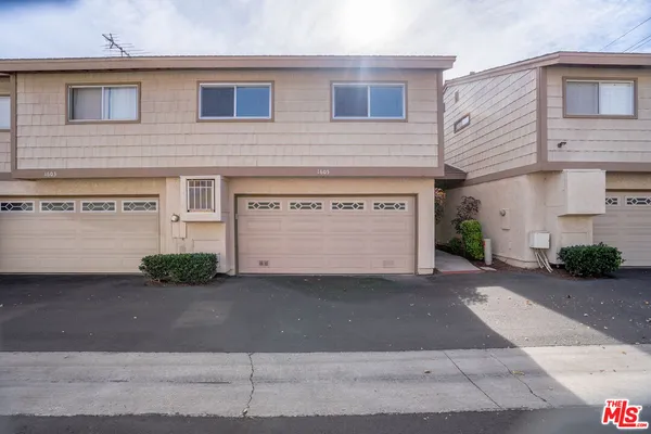 a front view of a house with a street