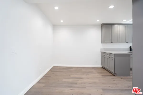 a kitchen with a sink cabinets and wooden floor