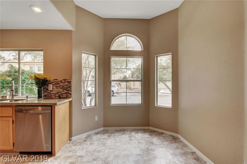 2647 Ridgewater Circle Henderson, NV 89074 - Photo 5 of 26 An arched window alcove illuminates this cozy casual dining area adjoining the kitchen.