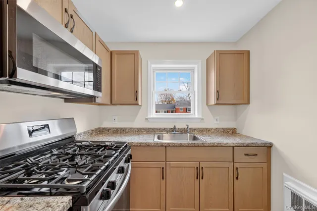 a kitchen with cabinets and steel stainless steel appliances