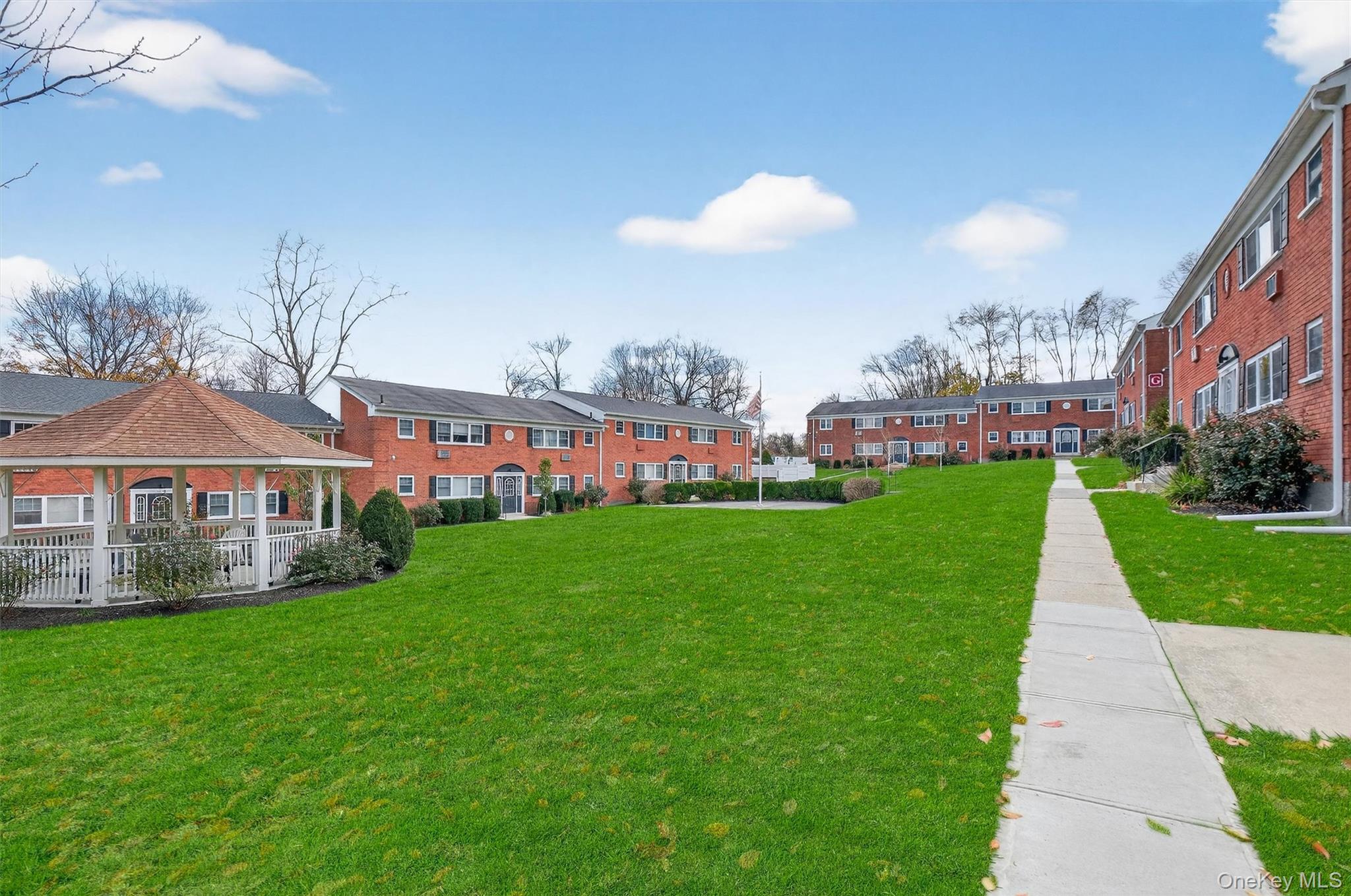 1879 Crompond Road, Unit F13 Peekskill, NY 10566 - Photo 18 of 24 front view of a house with a yard