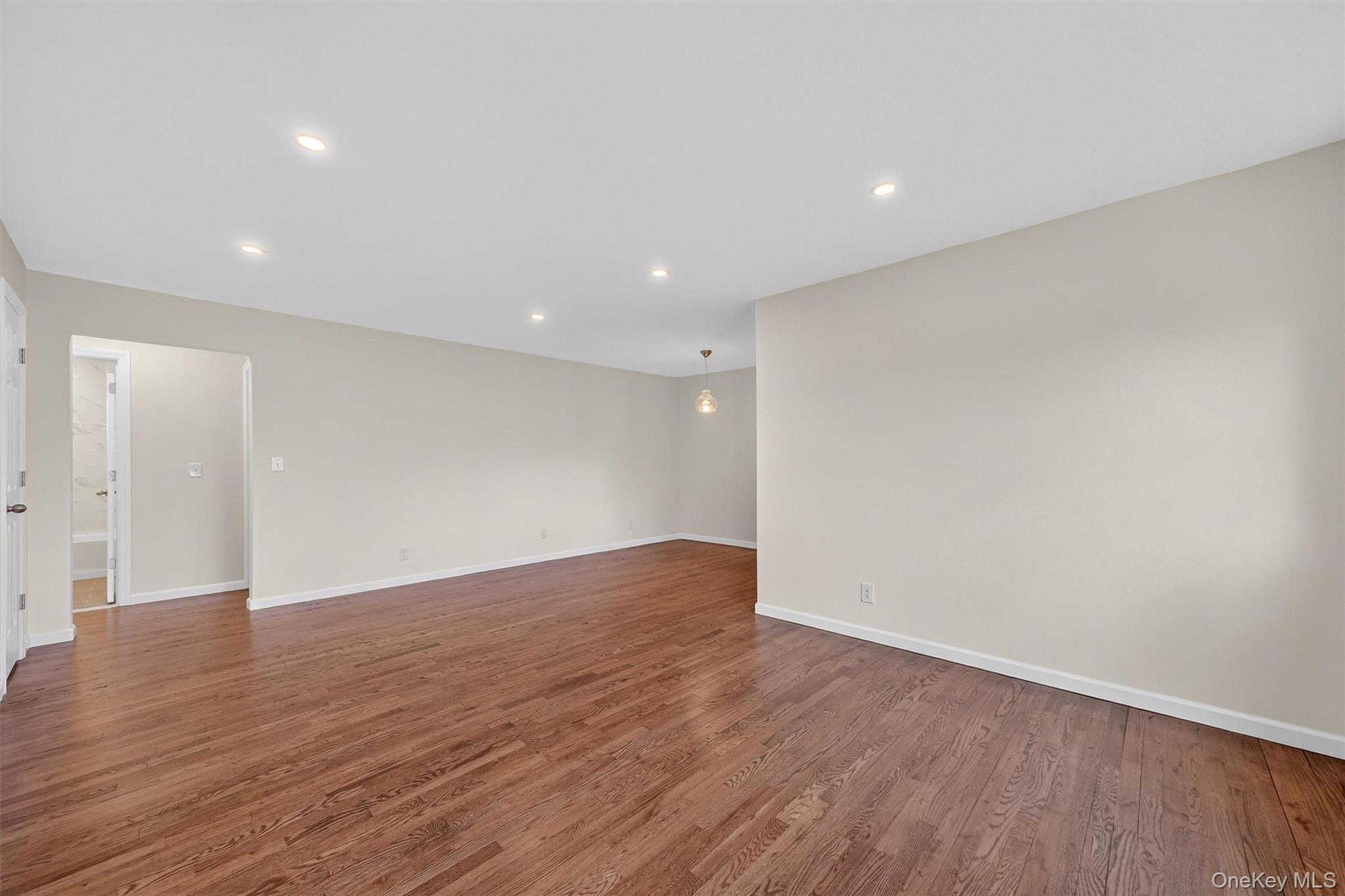 1879 Crompond Road, Unit F13 Peekskill, NY 10566 - Photo 5 of 24 a view of an empty room with wooden floor