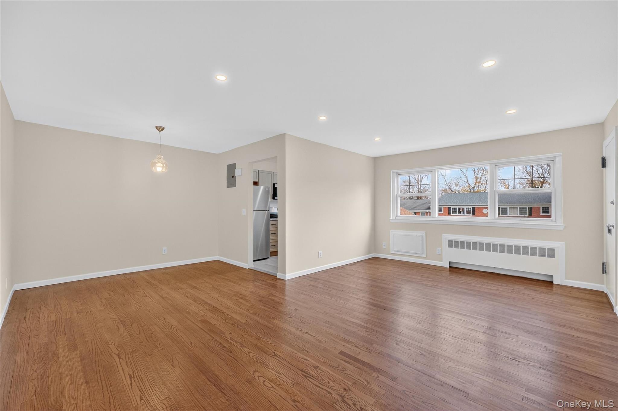 1879 Crompond Road, Unit F13 Peekskill, NY 10566 - Photo 6 of 24 a view of an empty room with a window and wooden floor