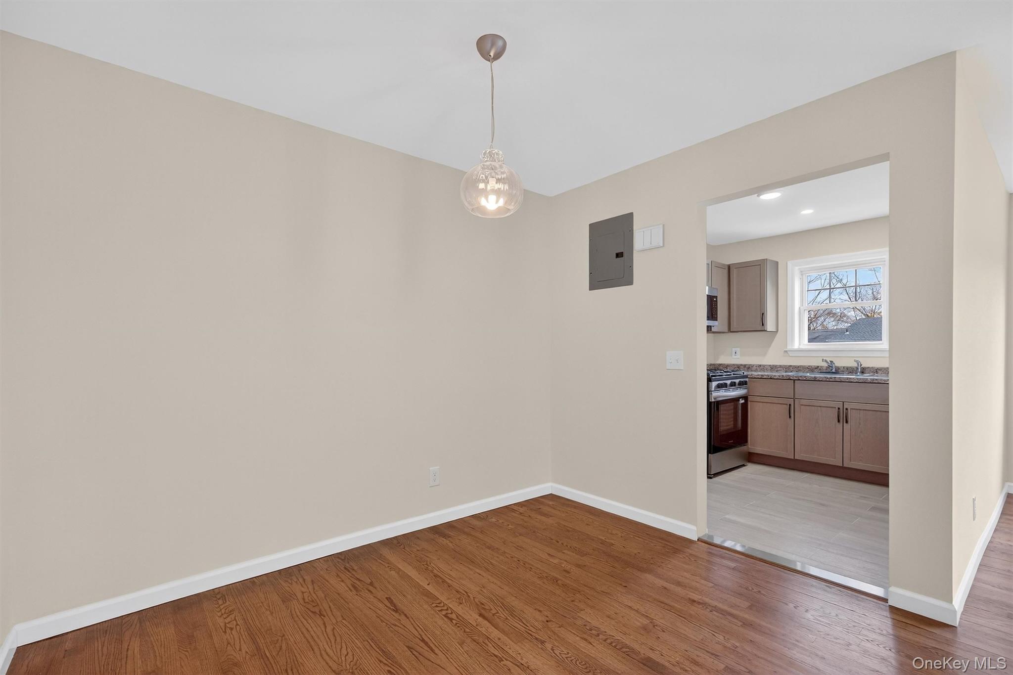 1879 Crompond Road, Unit F13 Peekskill, NY 10566 - Photo 7 of 24 a view of a room with wooden floor and kitchen view