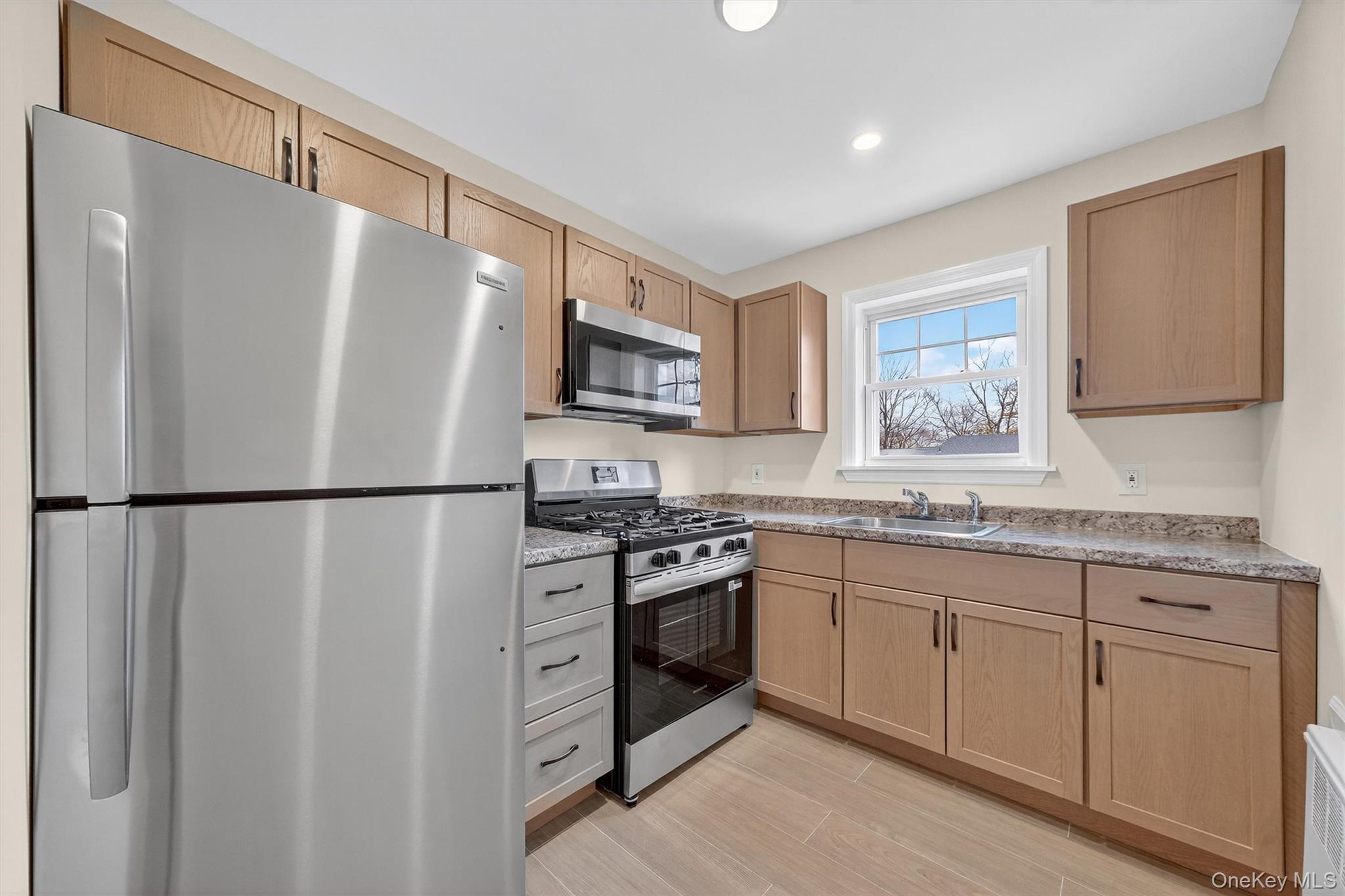 1879 Crompond Road, Unit F13 Peekskill, NY 10566 - Photo 8 of 24 a kitchen with stainless steel appliances a refrigerator sink and microwave