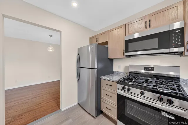 a kitchen with stainless steel appliances a refrigerator sink and microwave