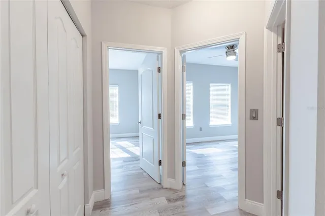 a view of a bathroom from a hallway with wooden floor