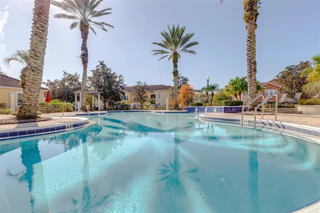a view of swimming pool with a yard and lake view