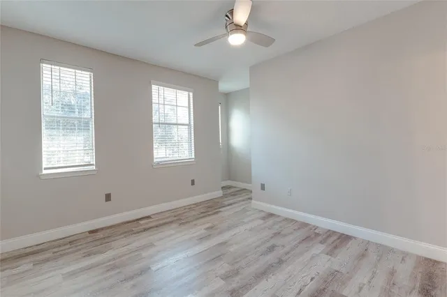 wooden floor in an empty room with a window