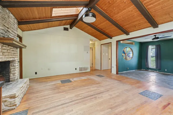 a view of a livingroom with a fireplace and a kitchen