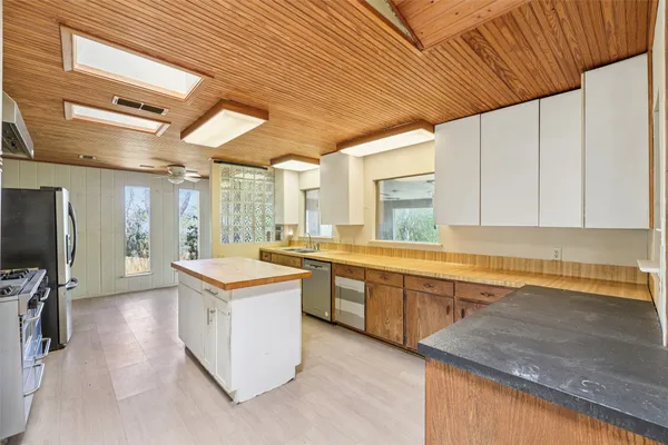 a large kitchen with lots of counter space and windows