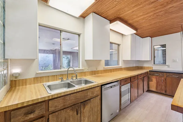 a kitchen with a sink and cabinets