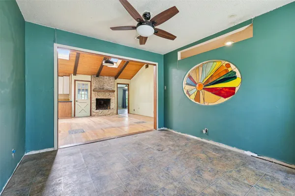 an empty room with window and fan