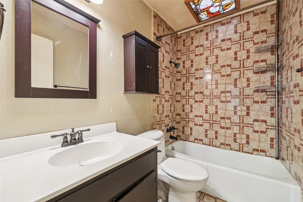 a bathroom with a sink a toilet and shower curtain