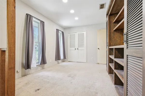 a view of an empty room with a closet